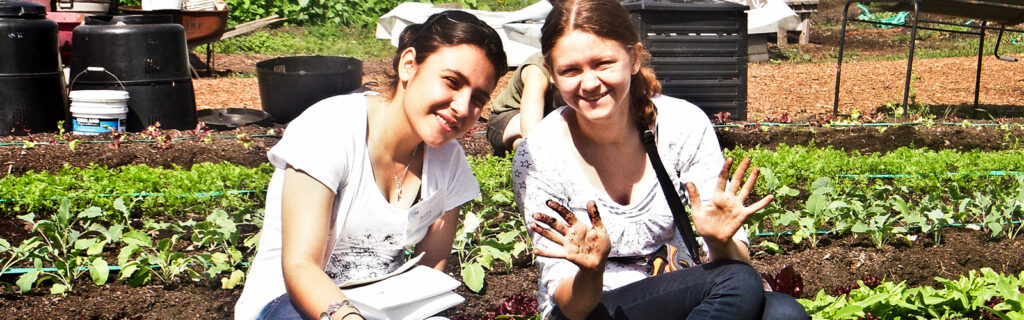 Tatiana gardening with another international exchange student