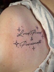 Loud Proud and Passionate tattoo on Mil's right shoulder.