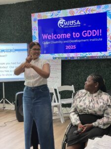 WILD Delegate signs to welcome participants to GDDI 2025