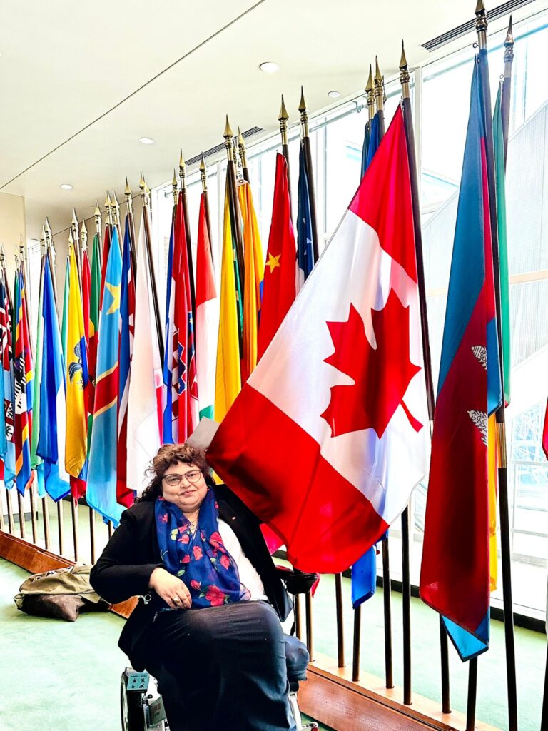 Meenu holding the Canadian flag.